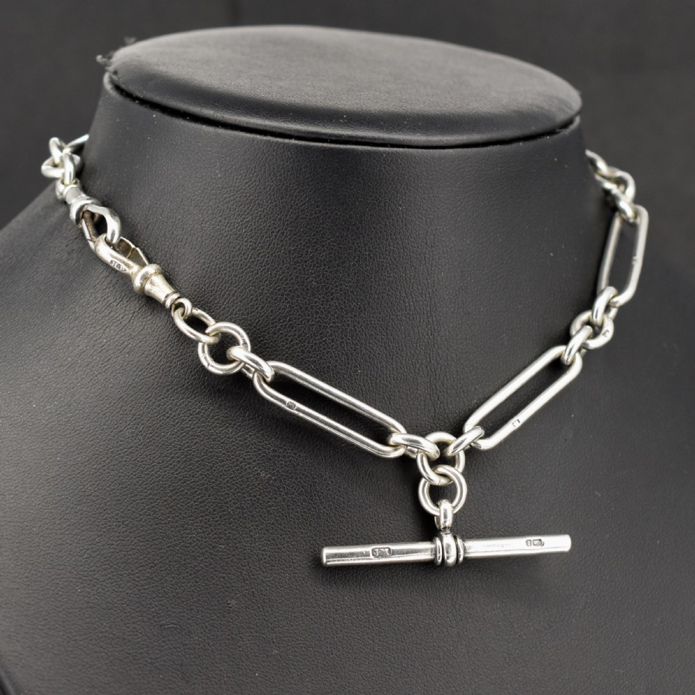 An antique sterling silver trombone link pocket watch chain with a T-bar attachment and dog clip fastener. View III