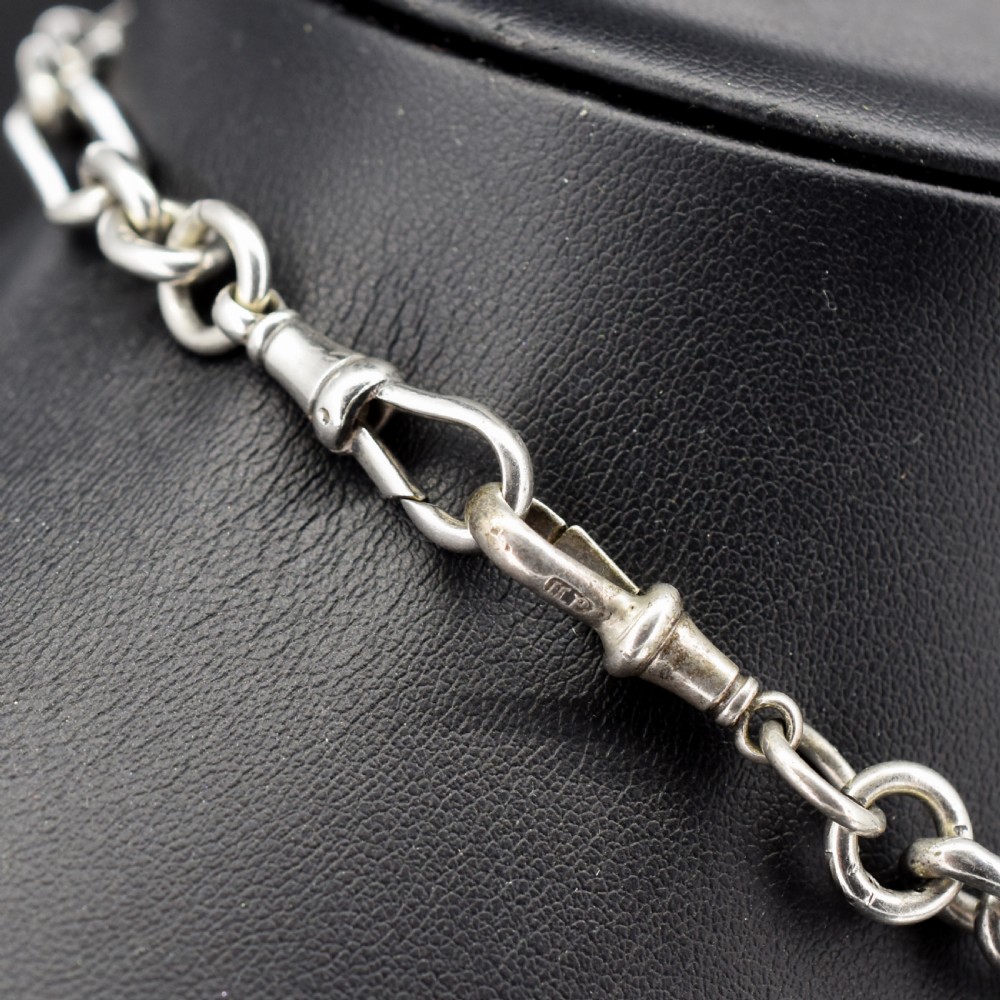 An antique sterling silver trombone link pocket watch chain with a T-bar attachment and dog clip fastener. View IV