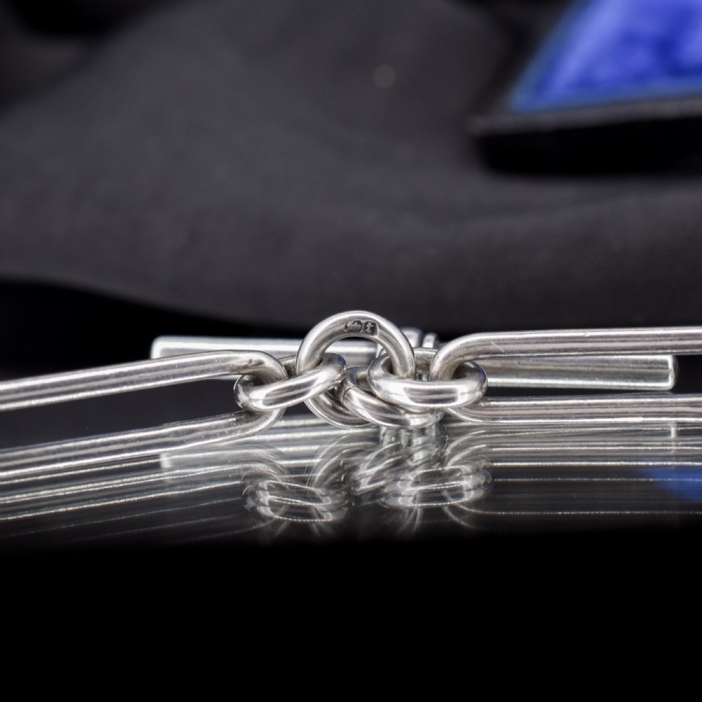 An antique sterling silver trombone link pocket watch chain with a T-bar attachment and dog clip fastener. View VI