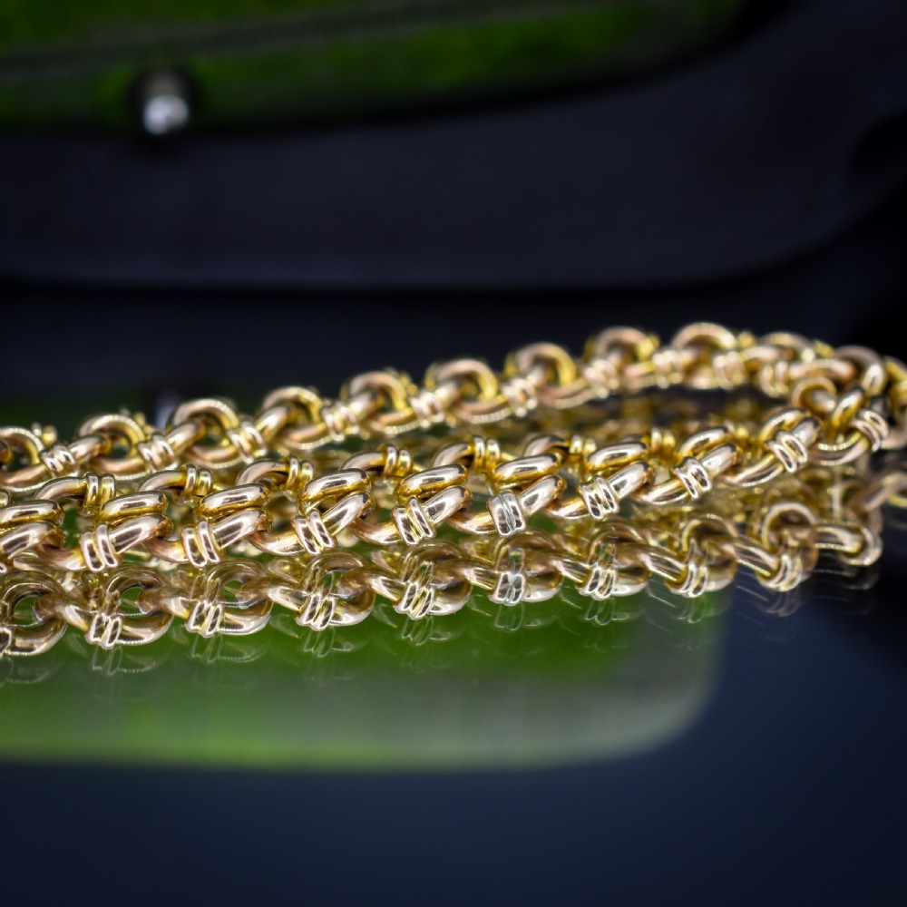 An antique 15ct yellow gold gate link bracelet fitted with an engraved heart padlock clasp and a safety chain. View VI