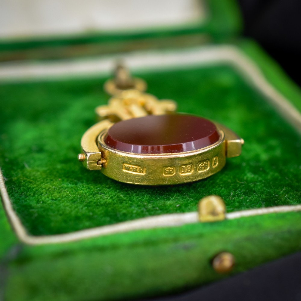 An antique Victorian 18ct gold spinning fob watch key pendant featuring a swivel-set oval dark green bloodstone with red flecks held within a scrolled mount. View III