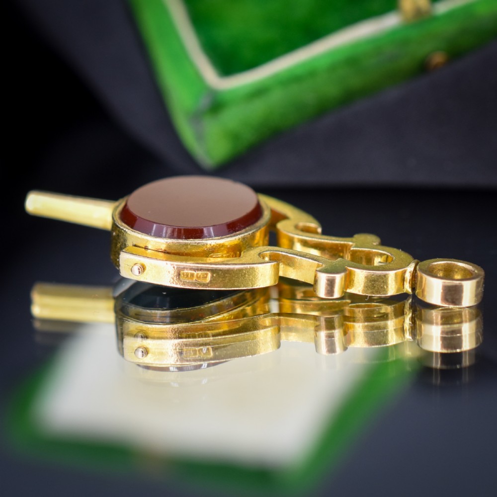An antique Victorian 18ct gold spinning fob watch key pendant featuring a swivel-set oval dark green bloodstone with red flecks held within a scrolled mount. View VI