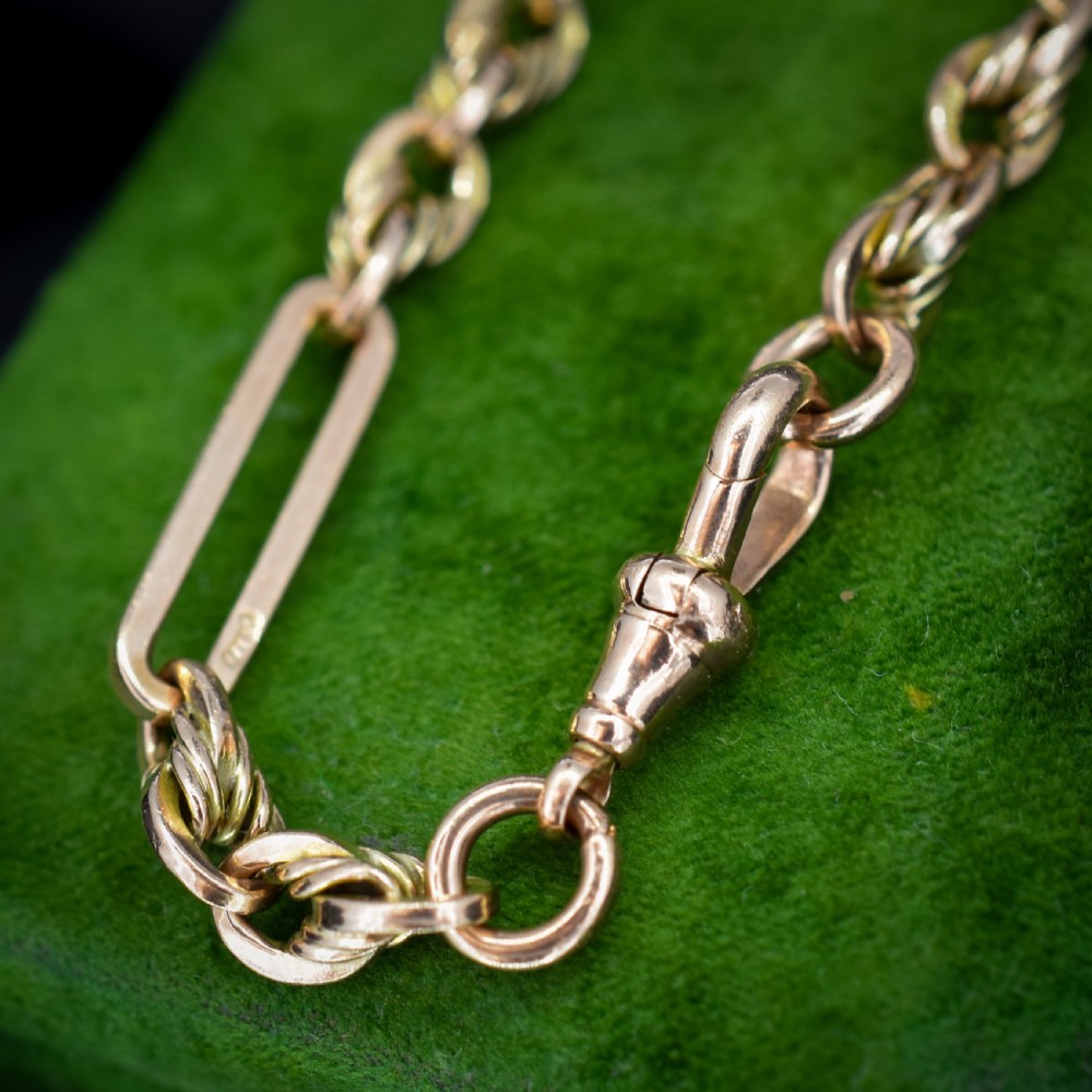 An antique 9ct yellow gold link bracelet composed of alternating trombone links and twisted love knots with a dog clip clasp. View VI