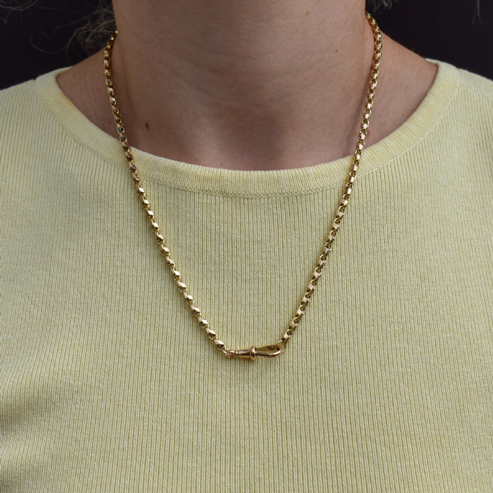 An antique 9ct yellow gold tulip link chain necklace featuring an integrated swivel dog clip clasp. View II