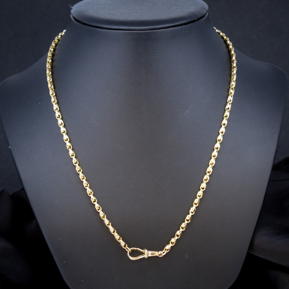 An antique 9ct yellow gold tulip link chain necklace featuring an integrated swivel dog clip clasp. View IV