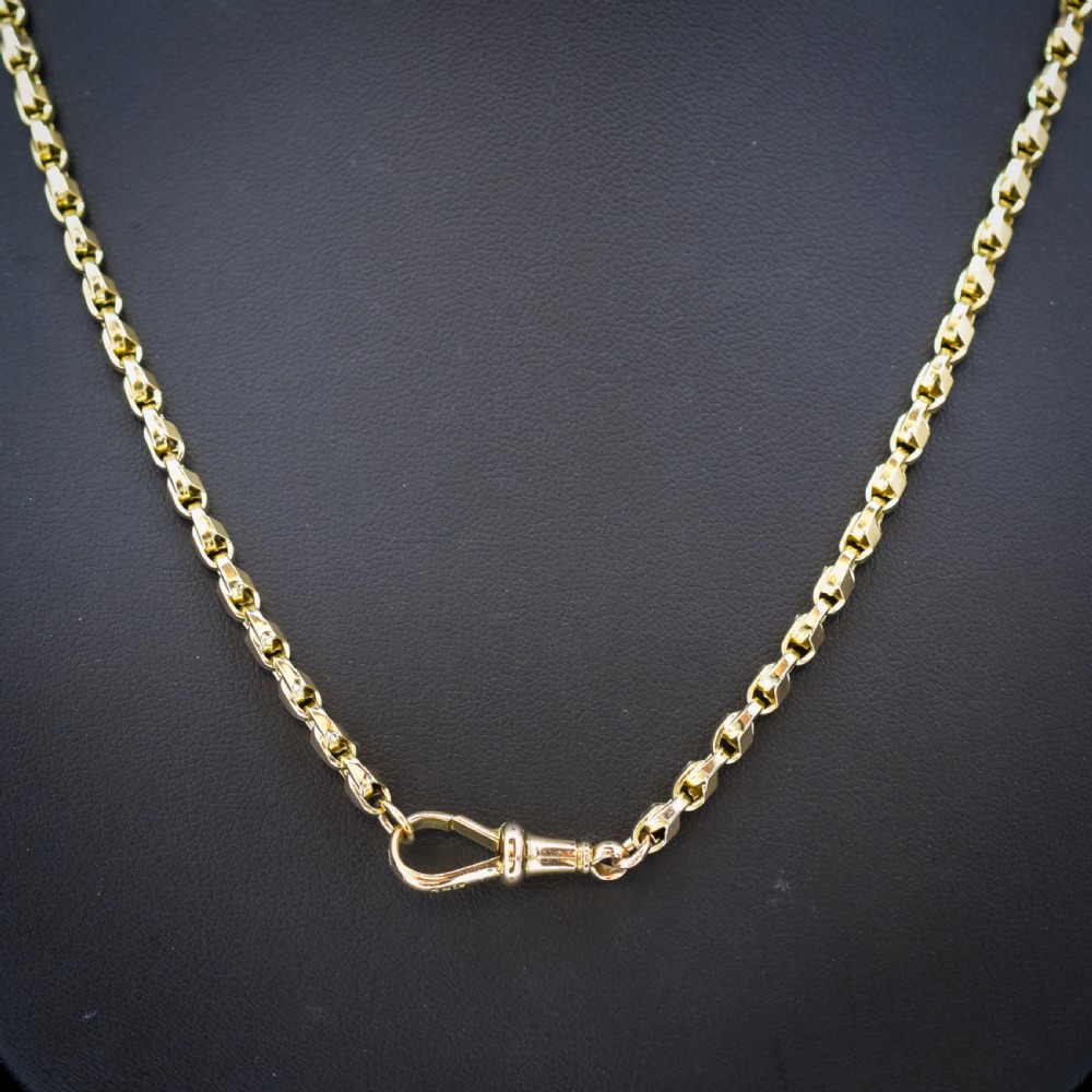 An antique 9ct yellow gold tulip link chain necklace featuring an integrated swivel dog clip clasp. View V