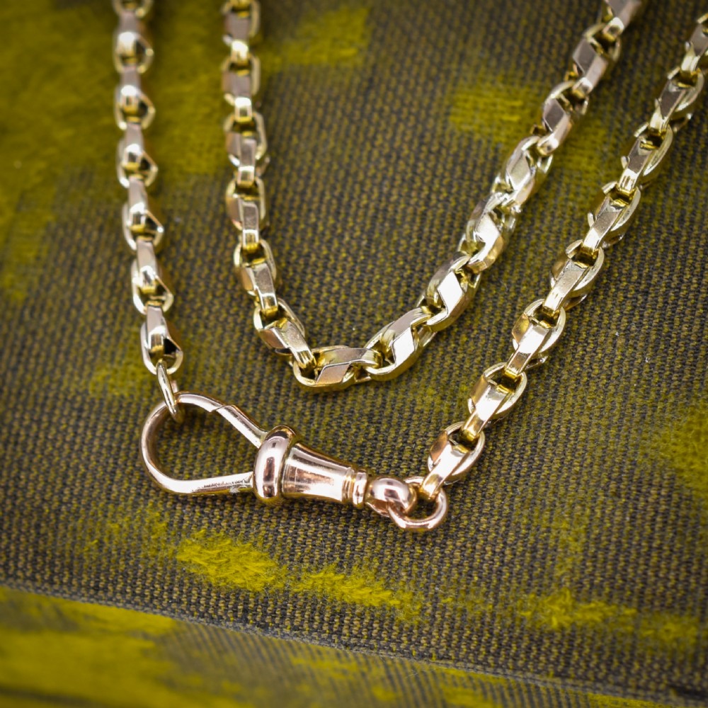 An antique 9ct yellow gold tulip link chain necklace featuring an integrated swivel dog clip clasp. View VII