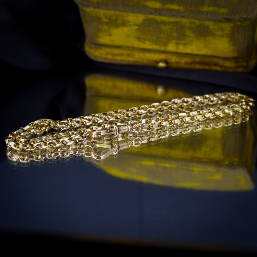 An antique 9ct yellow gold tulip link chain necklace featuring an integrated swivel dog clip clasp. View VIII