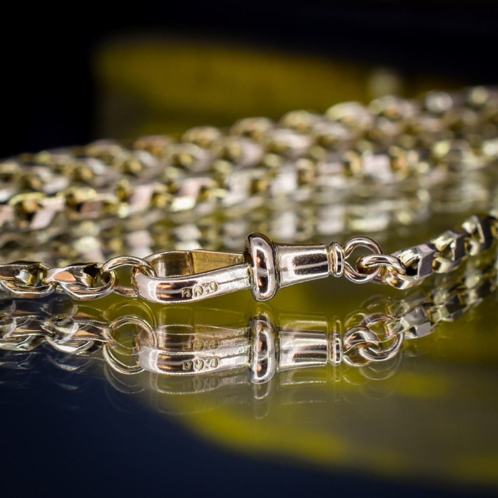 An antique 9ct yellow gold tulip link chain necklace featuring an integrated swivel dog clip clasp. View IX