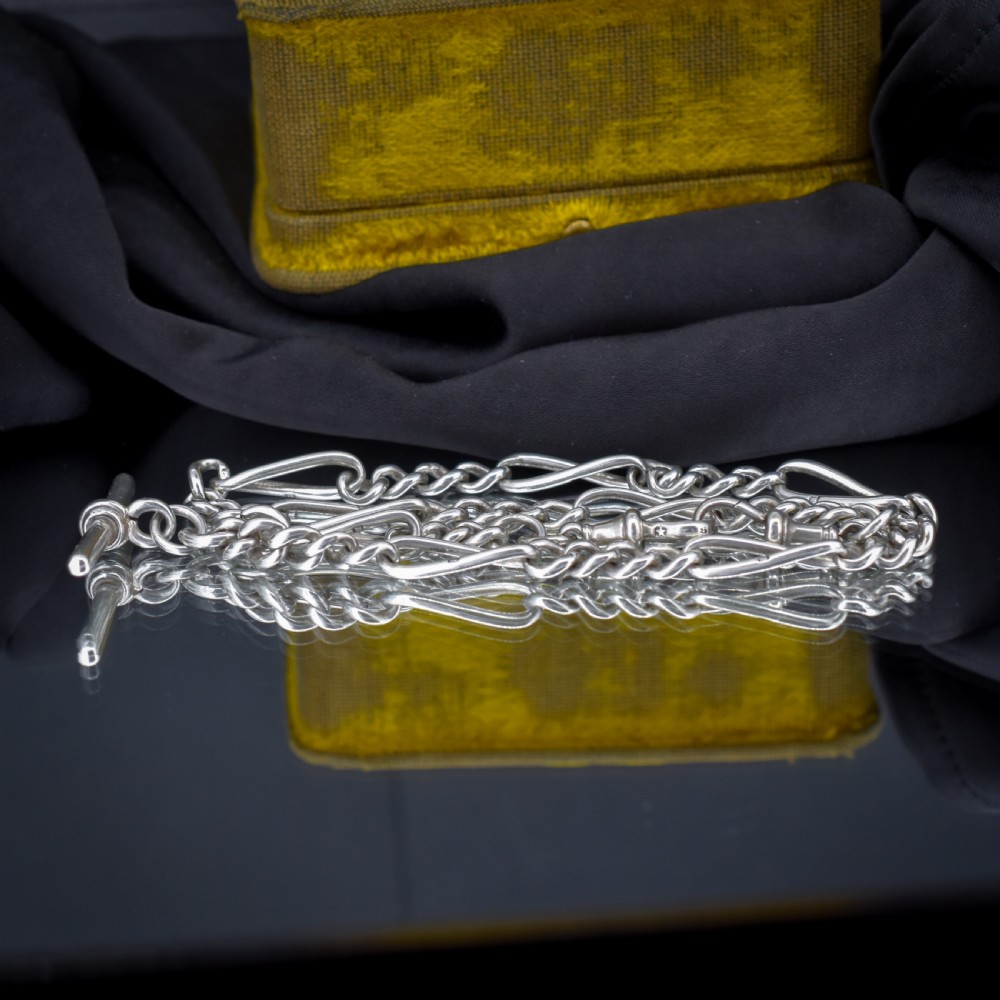 An antique sterling silver double Albert watch chain featuring Figaro style links, a central T-bar, and dual swivel clasps. View V