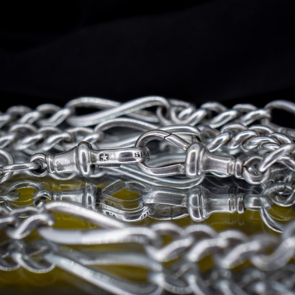 An antique sterling silver double Albert watch chain featuring Figaro style links, a central T-bar, and dual swivel clasps. View VI