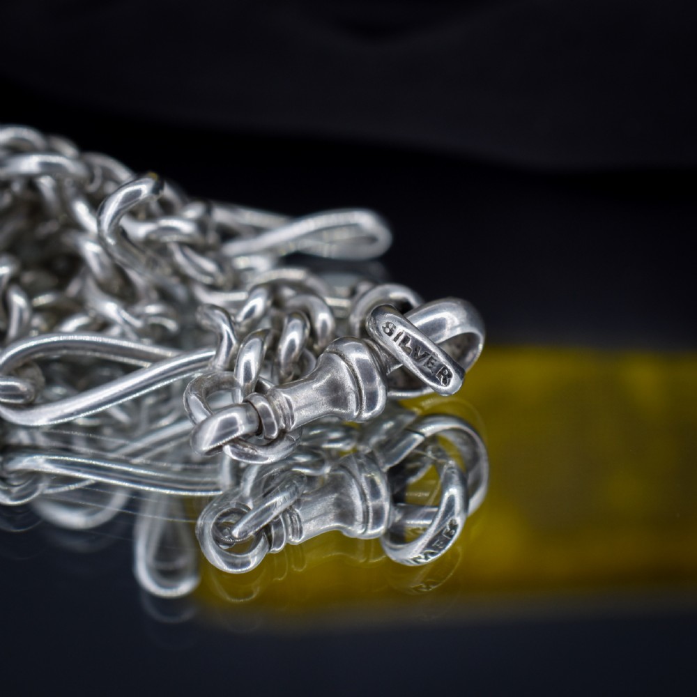 An antique sterling silver double Albert watch chain featuring Figaro style links, a central T-bar, and dual swivel clasps. View VII