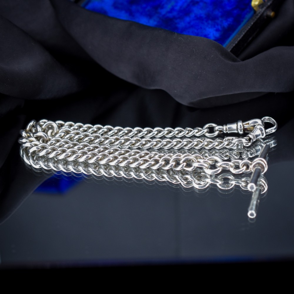 An antique sterling silver heavy curb link Albert watch chain featuring a T-bar and swivel clasp, displayed flat. View V
