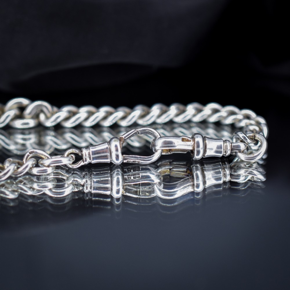 An antique sterling silver heavy curb link Albert watch chain featuring a T-bar and swivel clasp, displayed flat. View VI
