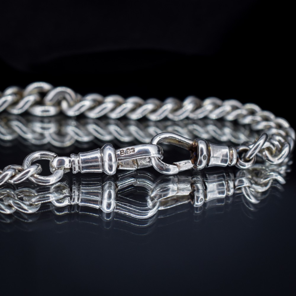 An antique sterling silver heavy curb link Albert watch chain featuring a T-bar and swivel clasp, displayed flat. View VII
