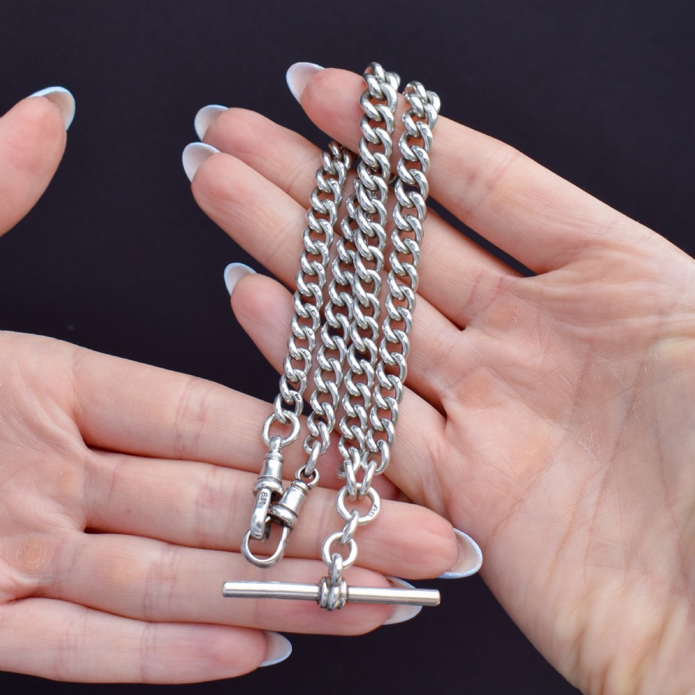 An antique sterling silver heavy curb link Albert watch chain featuring a T-bar and swivel clasp, displayed flat. View VIII