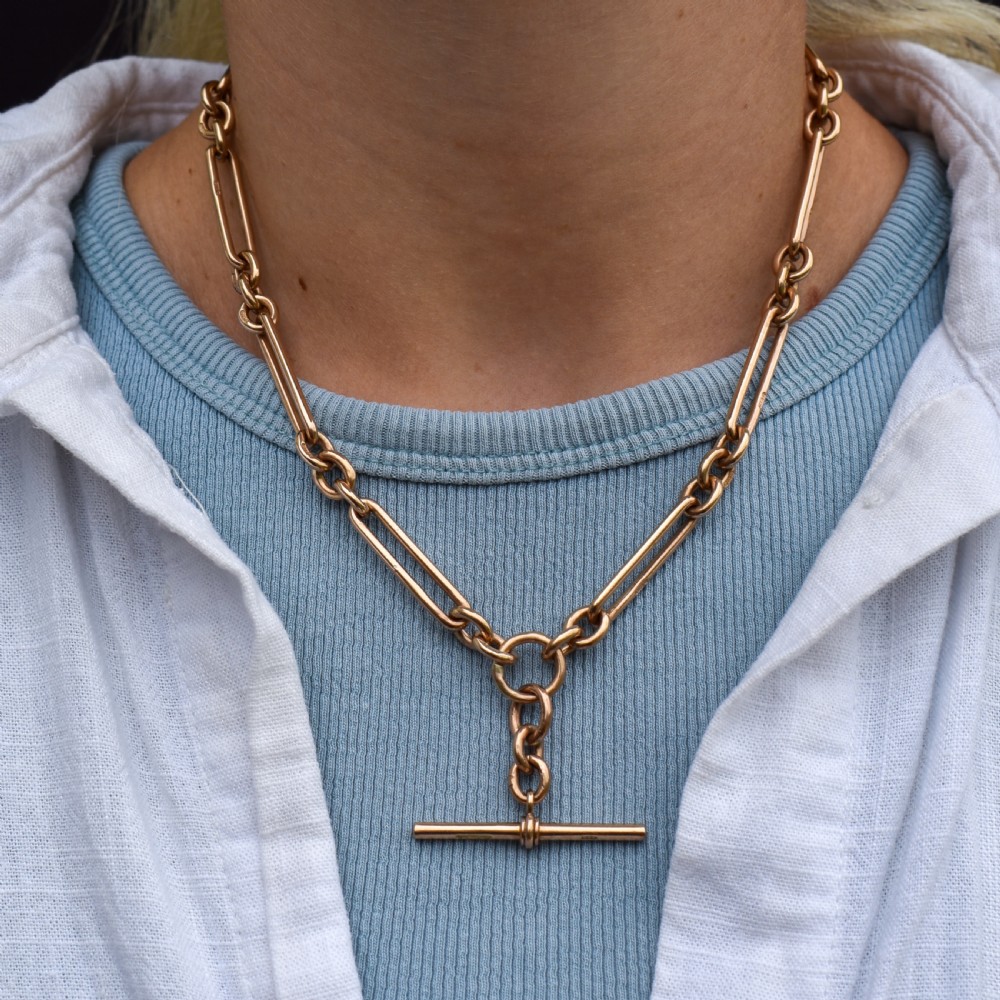 An antique 9ct gold trombone link Albert chain necklace with a T-bar, dog clip, and bolt ring clasp. View III