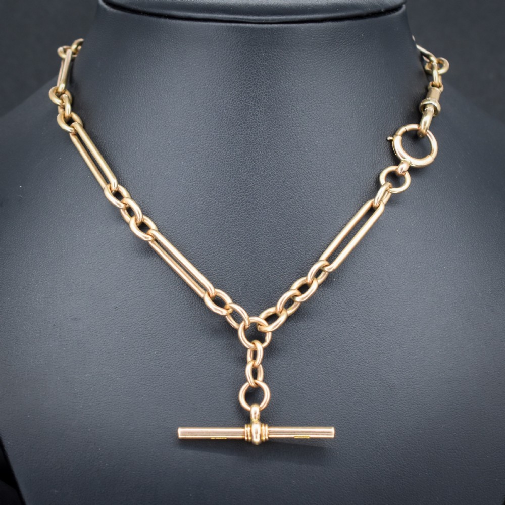 An antique 9ct gold trombone link Albert chain necklace with a T-bar, dog clip, and bolt ring clasp. View IV