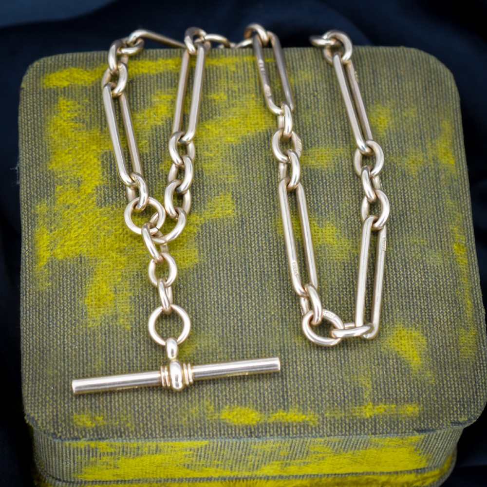 An antique 9ct gold trombone link Albert chain necklace with a T-bar, dog clip, and bolt ring clasp. View VI