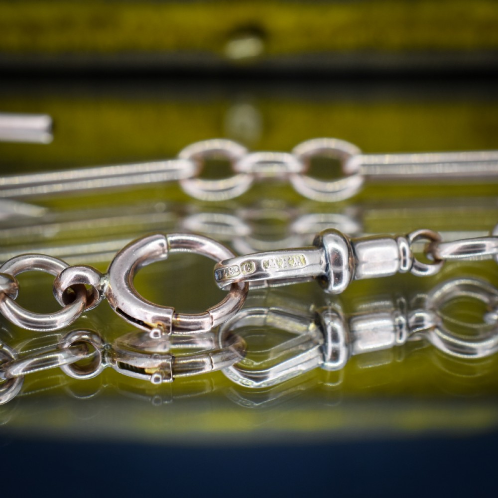 An antique 9ct gold trombone link Albert chain necklace with a T-bar, dog clip, and bolt ring clasp. View VIII