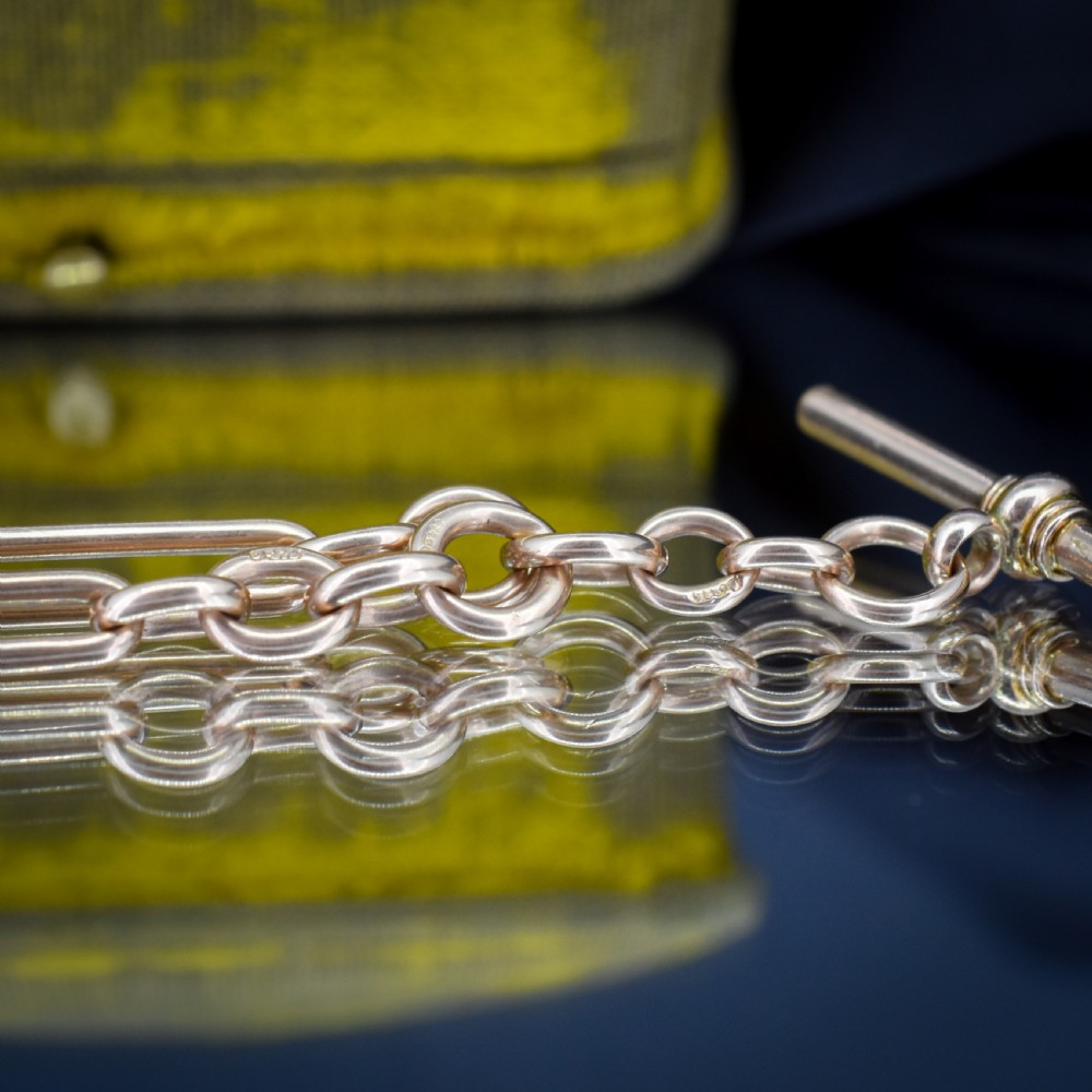 An antique 9ct gold trombone link Albert chain necklace with a T-bar, dog clip, and bolt ring clasp. View X