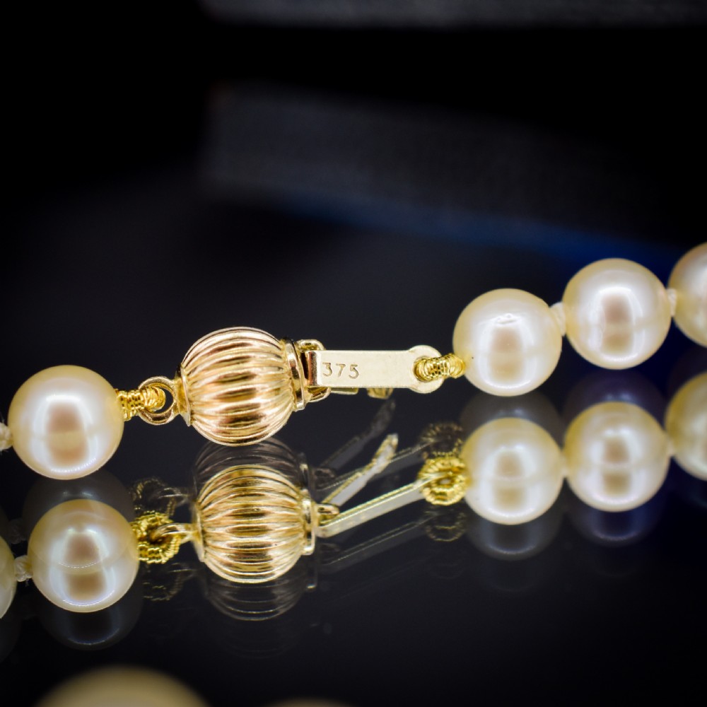 A graduated strand of cream pearls featuring a yellow gold fluted clasp. View VIII
