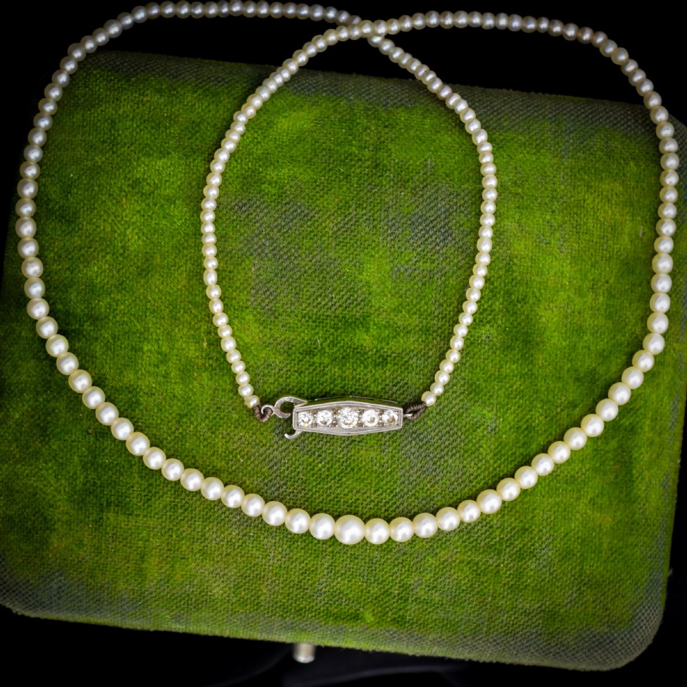 A single strand of graduated cream pearls fitted with an 18ct white gold clasp set with diamonds.