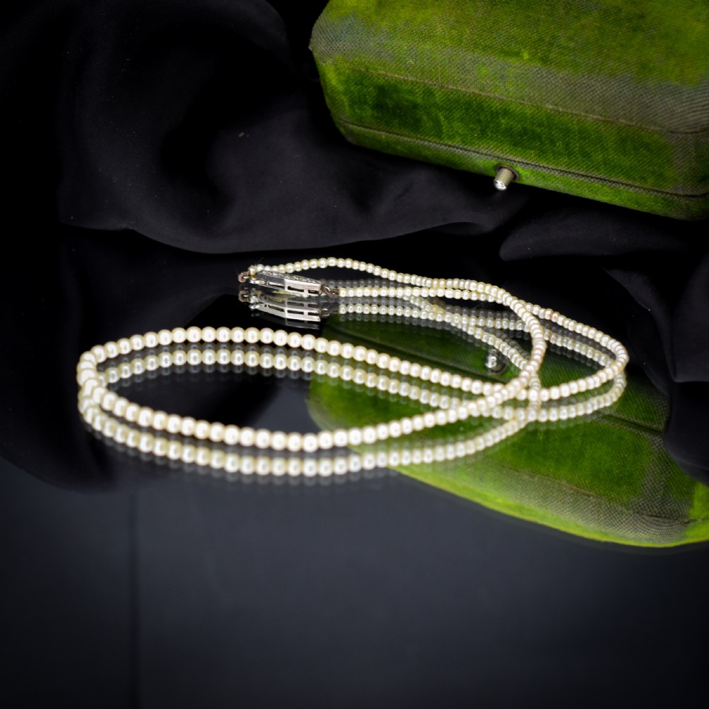 A single strand of graduated cream pearls fitted with an 18ct white gold clasp set with diamonds. View VI