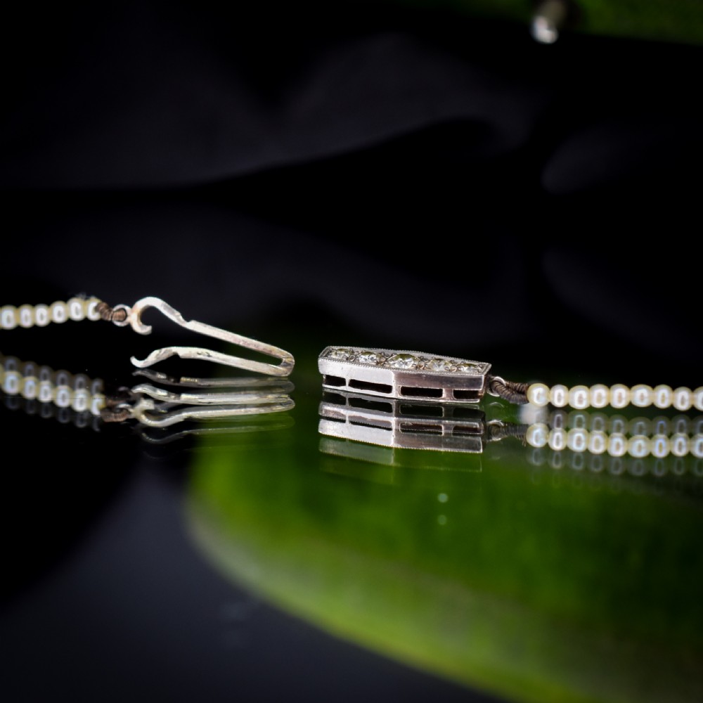 A single strand of graduated cream pearls fitted with an 18ct white gold clasp set with diamonds. View VIII