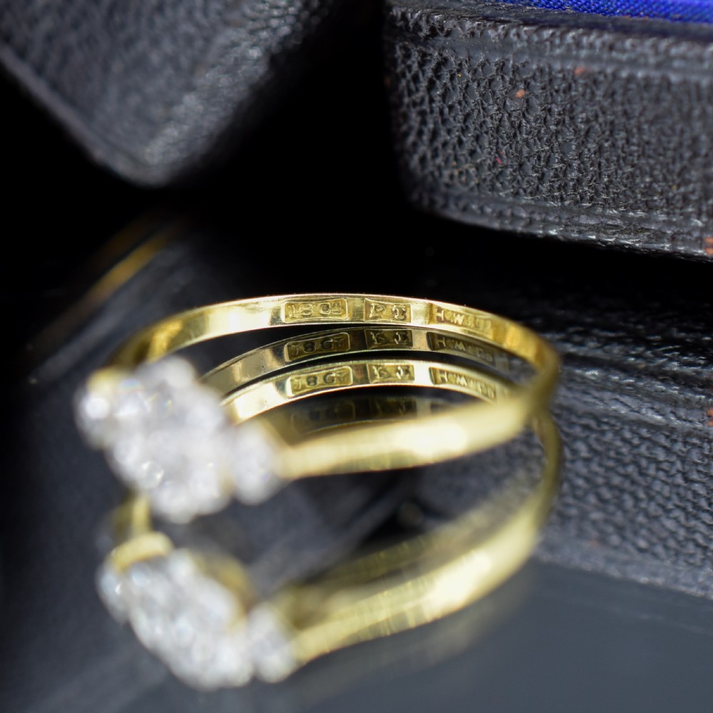 An Edwardian cluster ring crafted in yellow gold and platinum, featuring a central round diamond surrounded by a halo of diamonds with diamond-set shoulders. View VII