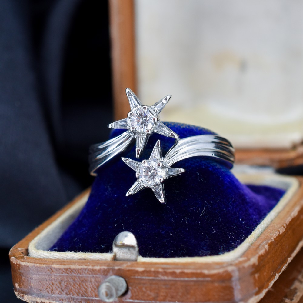 An 18ct white gold bypass ring featuring two star motifs set with brilliant-cut and baguette diamonds. View III