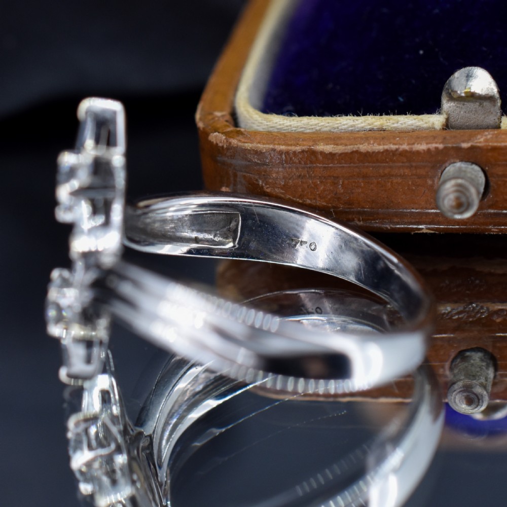 An 18ct white gold bypass ring featuring two star motifs set with brilliant-cut and baguette diamonds. View VII