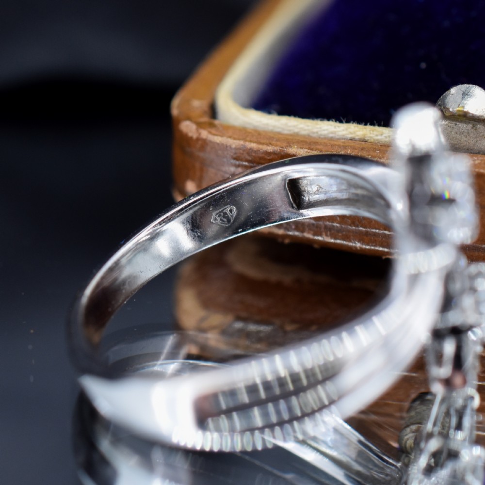 An 18ct white gold bypass ring featuring two star motifs set with brilliant-cut and baguette diamonds. View VIII