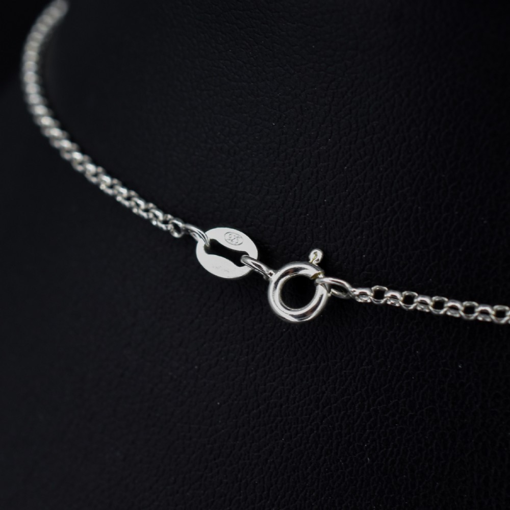 An antique silver festoon necklace featuring tiered oval cabochon moonstone drops suspended from a central chain. View VI