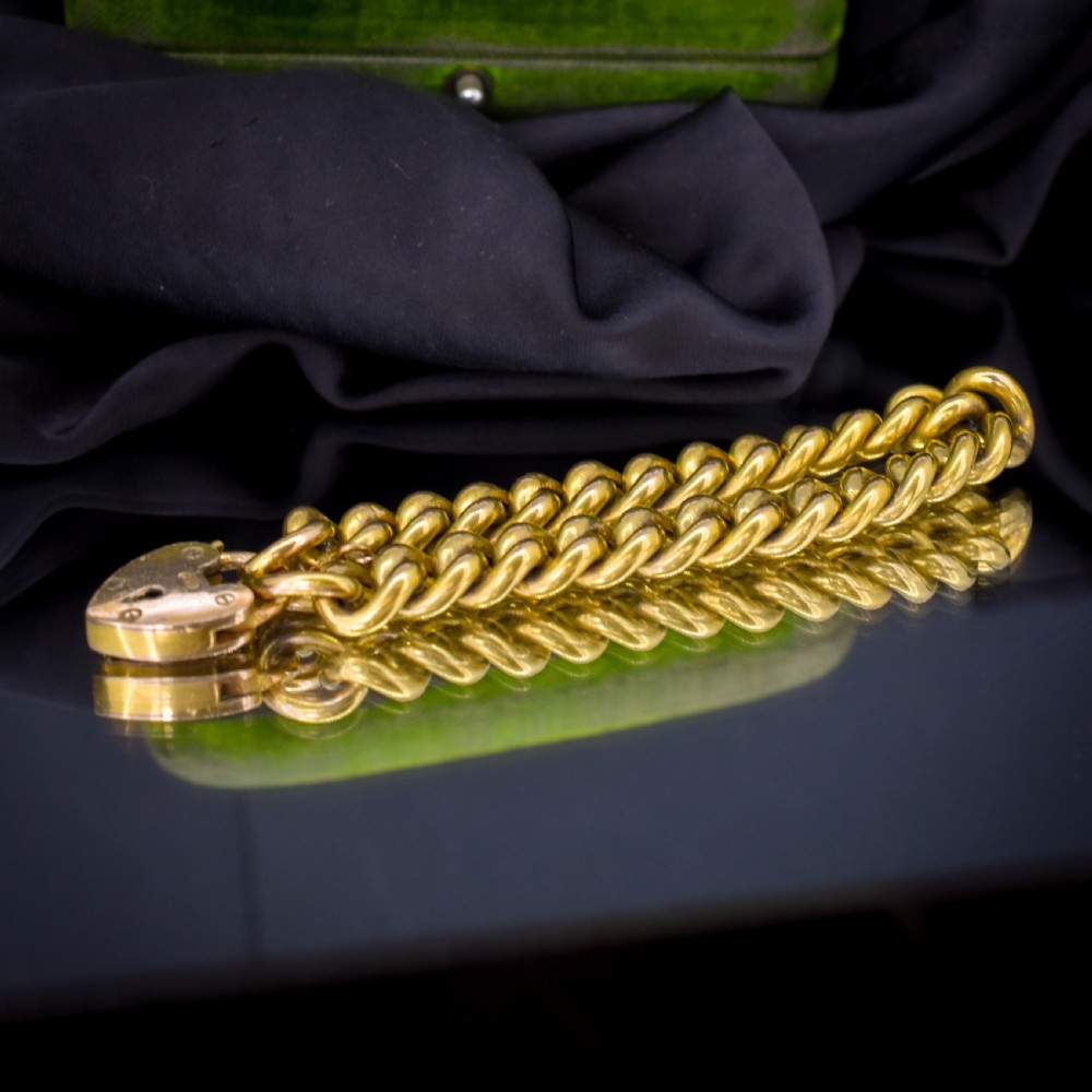 An antique rolled gold curb link bracelet featuring a heart-shaped padlock clasp and safety chain. View II