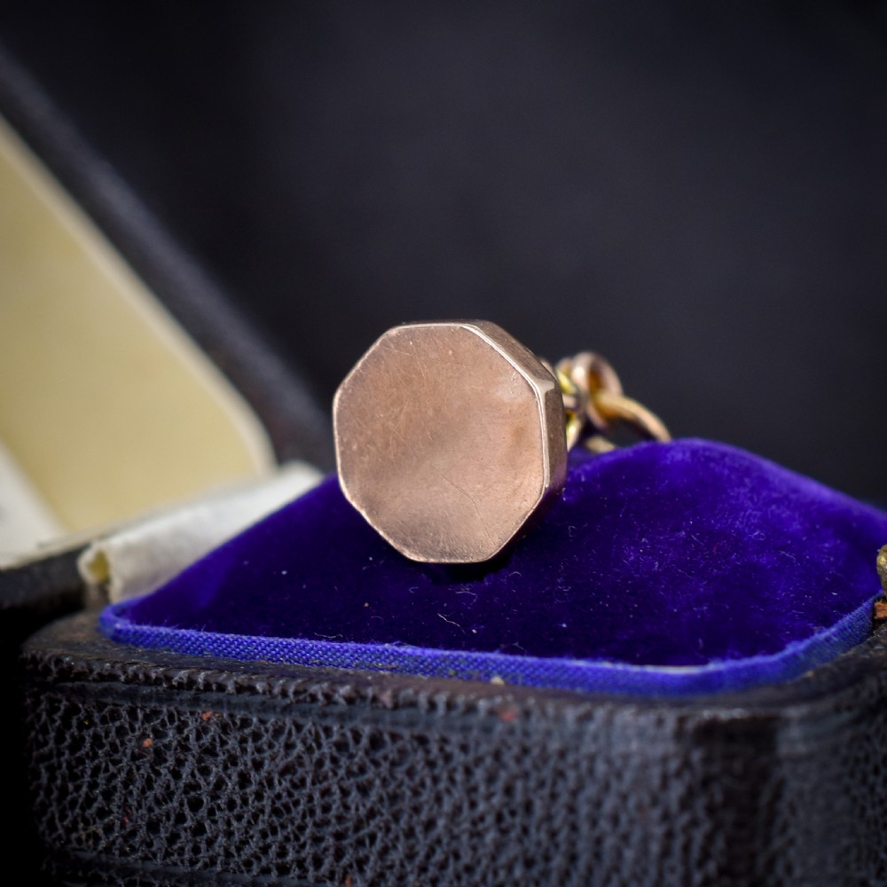 An antique 9ct yellow gold fob seal pendant featuring a looped wire handle design and a plain octagonal seal base. View III