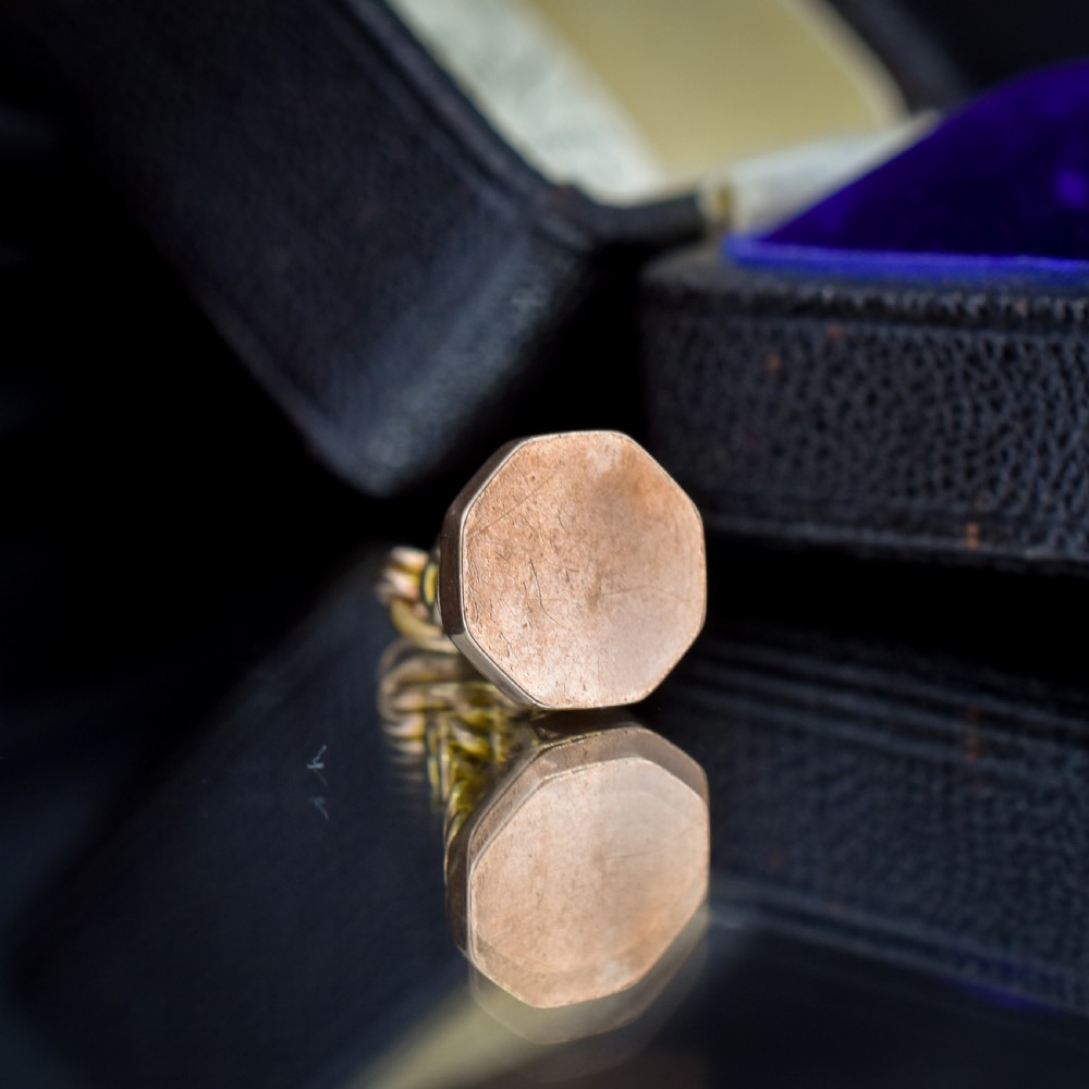 An antique 9ct yellow gold fob seal pendant featuring a looped wire handle design and a plain octagonal seal base. View V