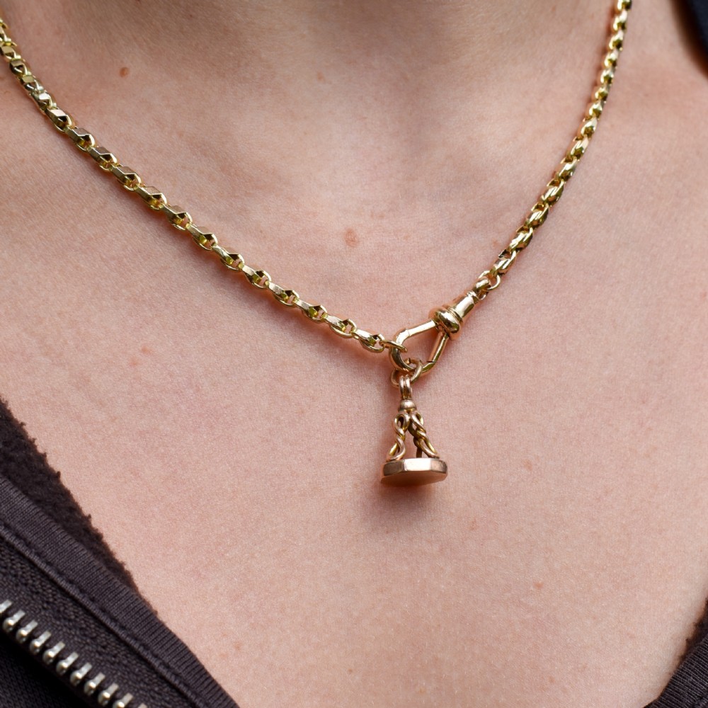 An antique 9ct yellow gold fob seal pendant featuring a looped wire handle design and a plain octagonal seal base. View VII