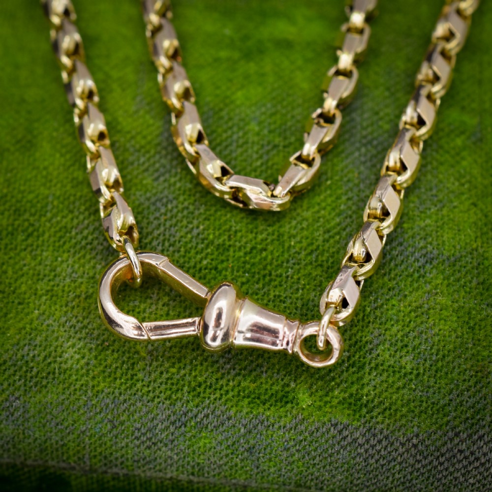 An antique 9ct yellow gold tulip link fancy chain necklace featuring a swivel dog clip clasp. View V