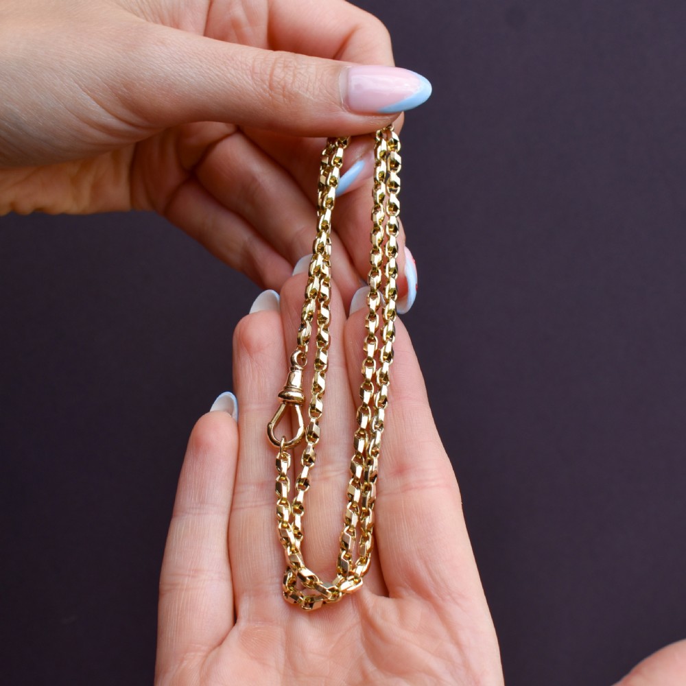 An antique 9ct yellow gold tulip link fancy chain necklace featuring a swivel dog clip clasp. View IX