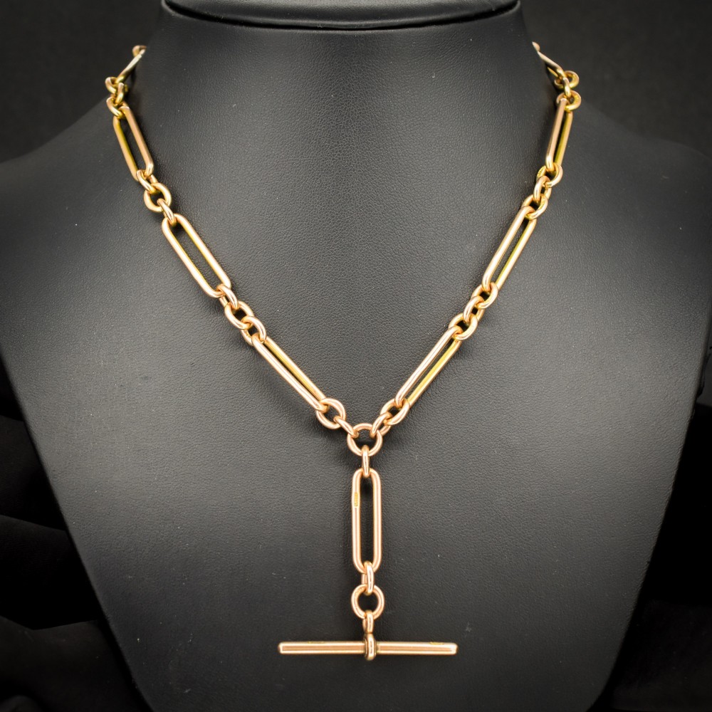 A 9ct yellow gold Albert chain necklace featuring alternating trombone links and a central T-bar pendant drop.