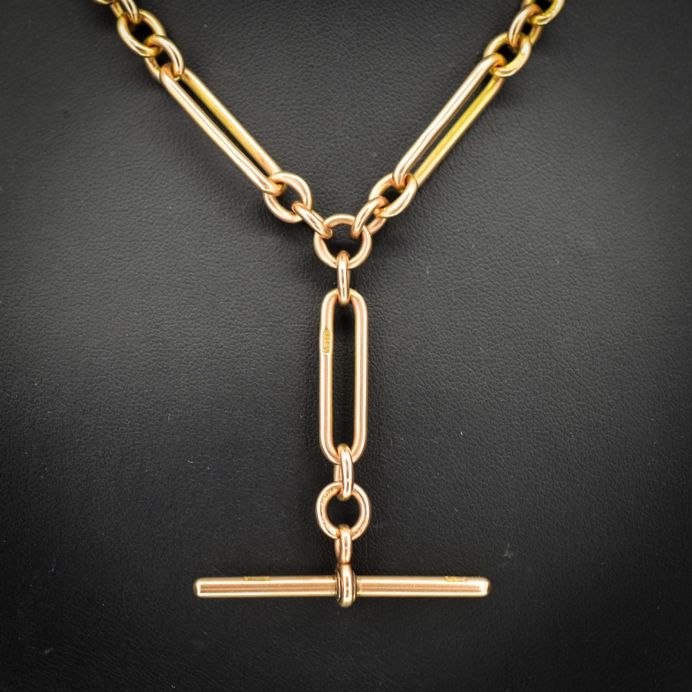 A 9ct yellow gold Albert chain necklace featuring alternating trombone links and a central T-bar pendant drop. View II