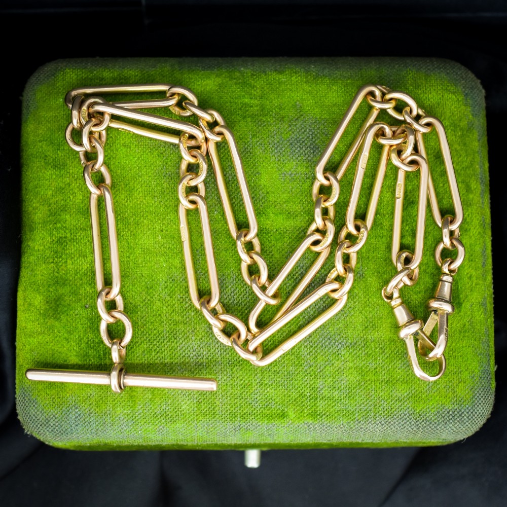 A 9ct yellow gold Albert chain necklace featuring alternating trombone links and a central T-bar pendant drop. View VI