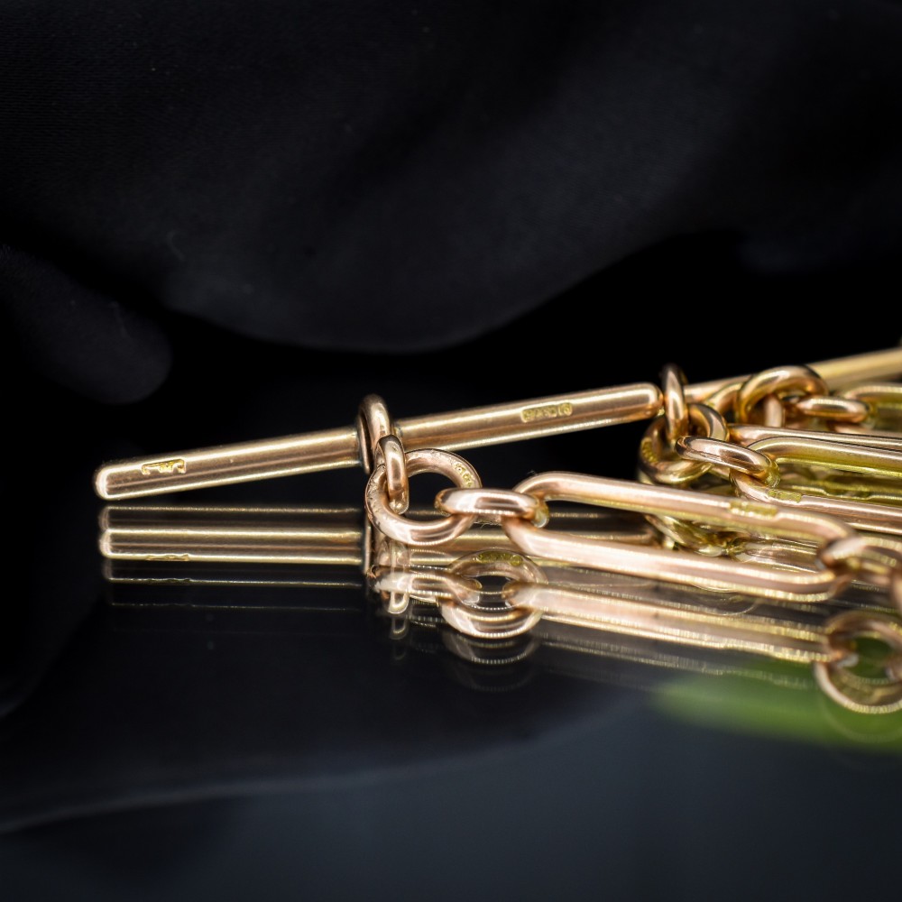 A 9ct yellow gold Albert chain necklace featuring alternating trombone links and a central T-bar pendant drop. View VII