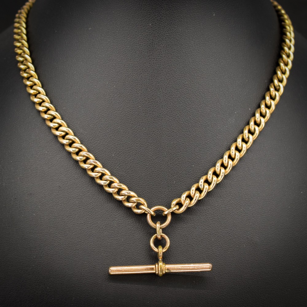 An antique rolled gold curb link watch chain featuring a central T-bar dropper and double dog clip fasteners. View II