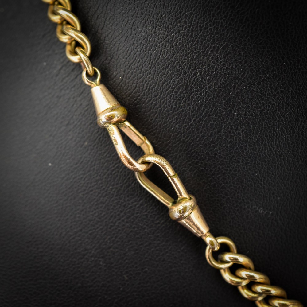 An antique rolled gold curb link watch chain featuring a central T-bar dropper and double dog clip fasteners. View V