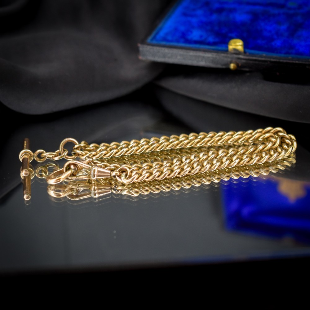 An antique rolled gold curb link watch chain featuring a central T-bar dropper and double dog clip fasteners. View VII