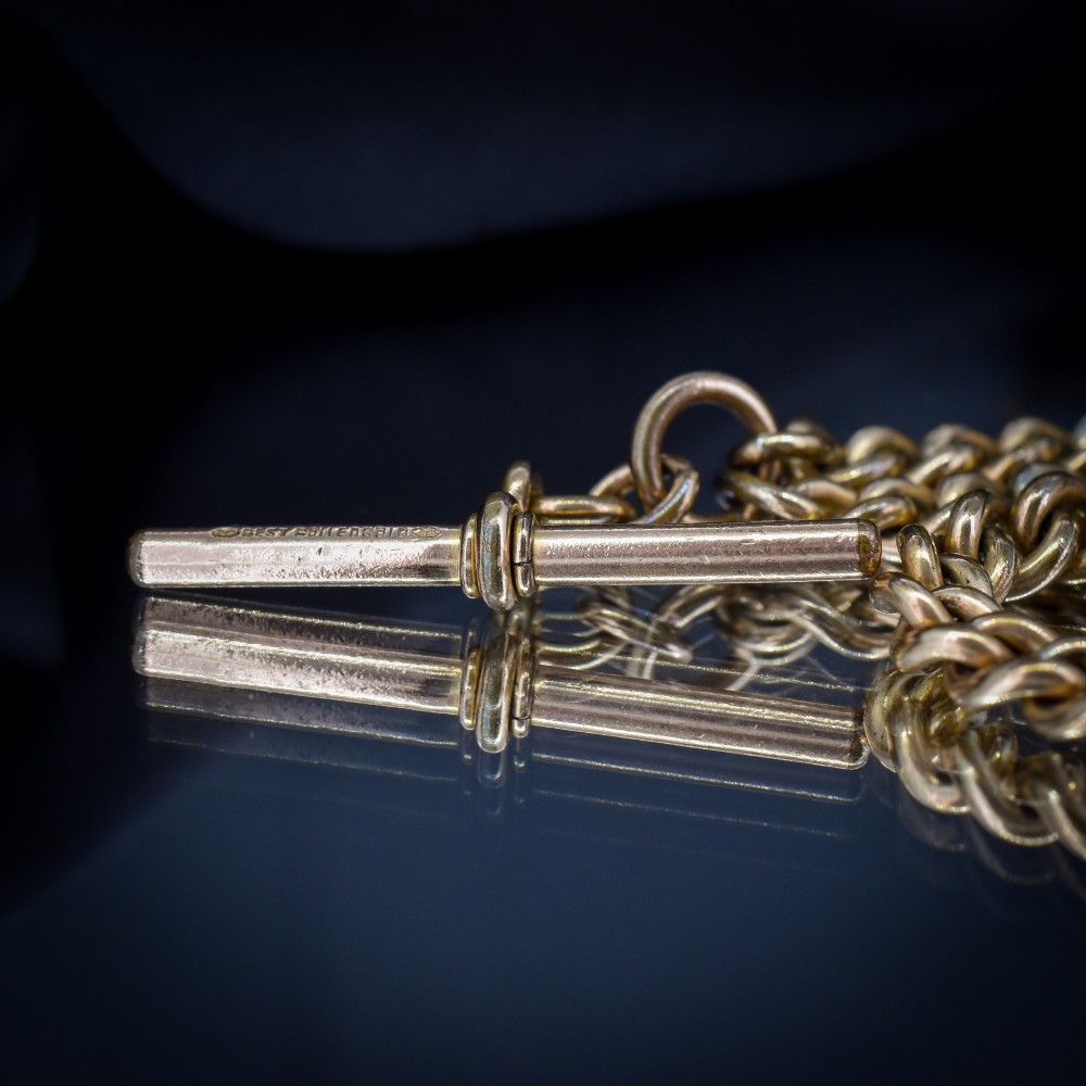 An antique rolled gold curb link watch chain featuring a central T-bar dropper and double dog clip fasteners. View VIII