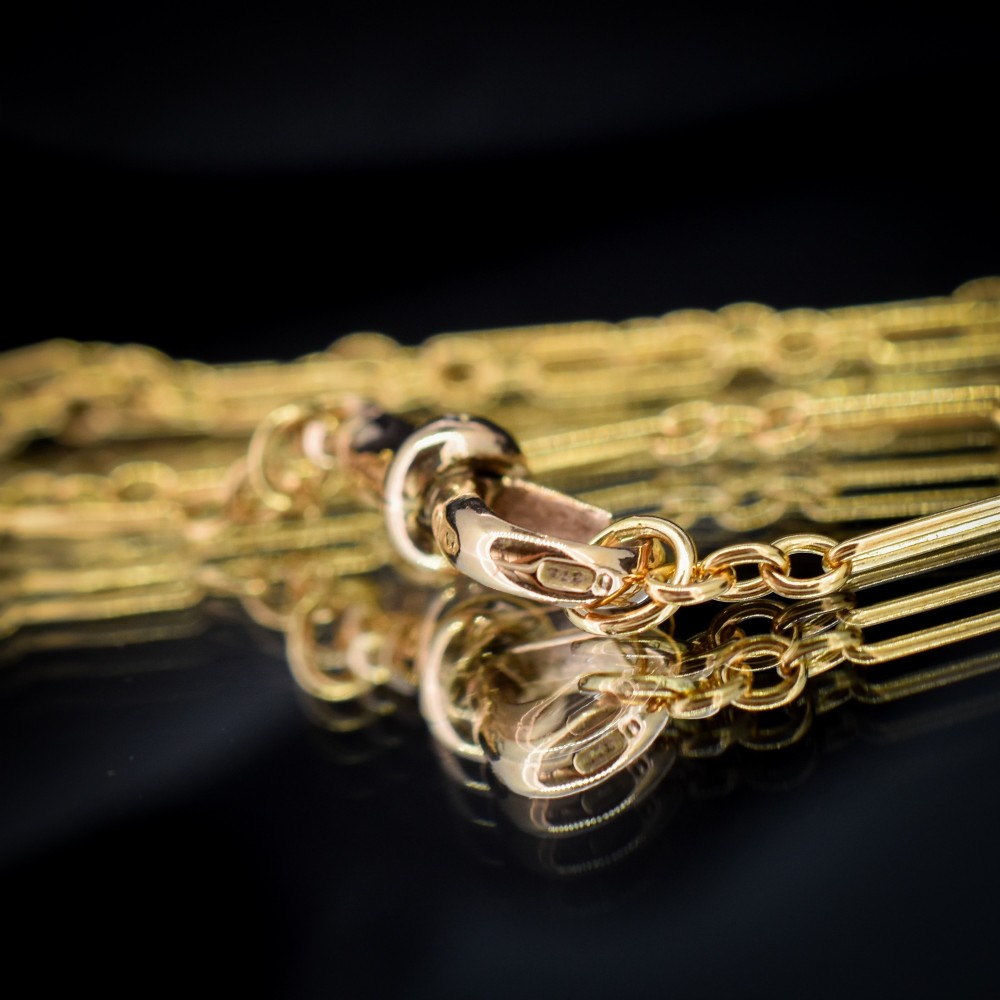 An antique 9ct yellow gold paperlink chain featuring elongated rectangular links and a dog clip swivel clasp. View VII