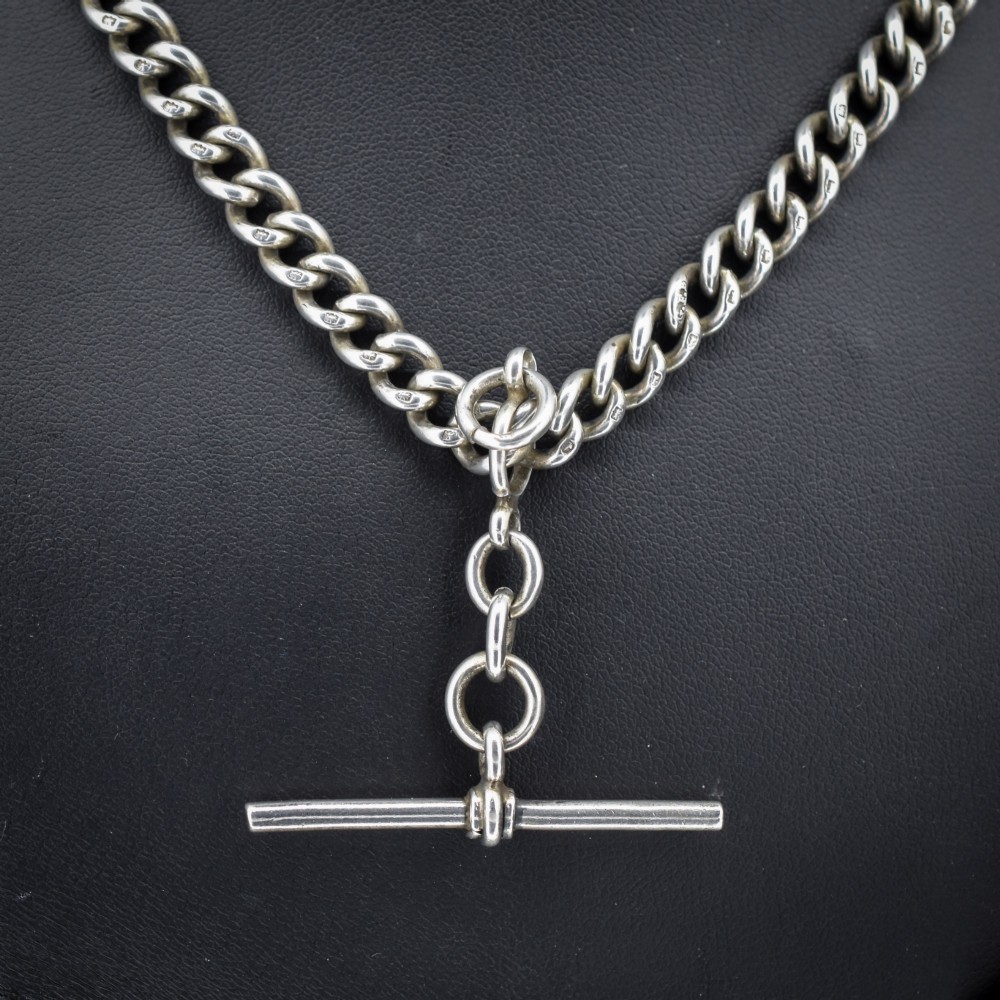 An antique sterling silver Albert watch chain featuring heavy curb links, a central T-bar drop, and two swivel dog clip clasps. View III